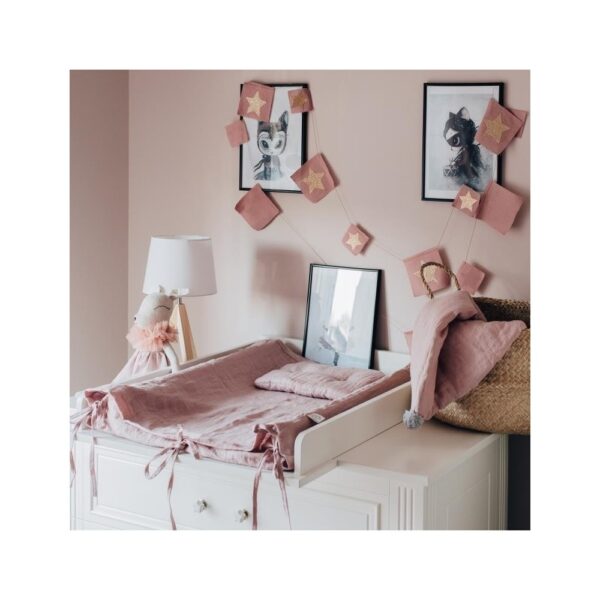 Baby room with changing table and linen changing cover with flat pillows and small towel