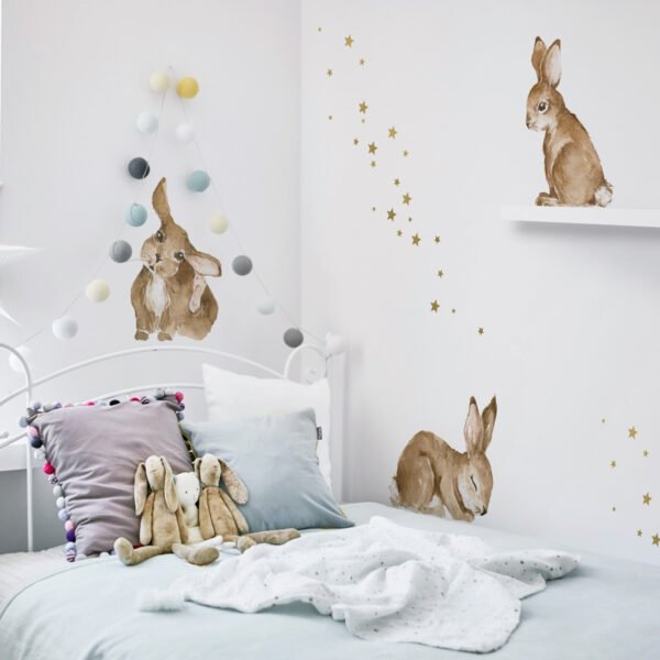 Children's room with wall stickers with three rabbits, one sleeping, one sitting and one watching