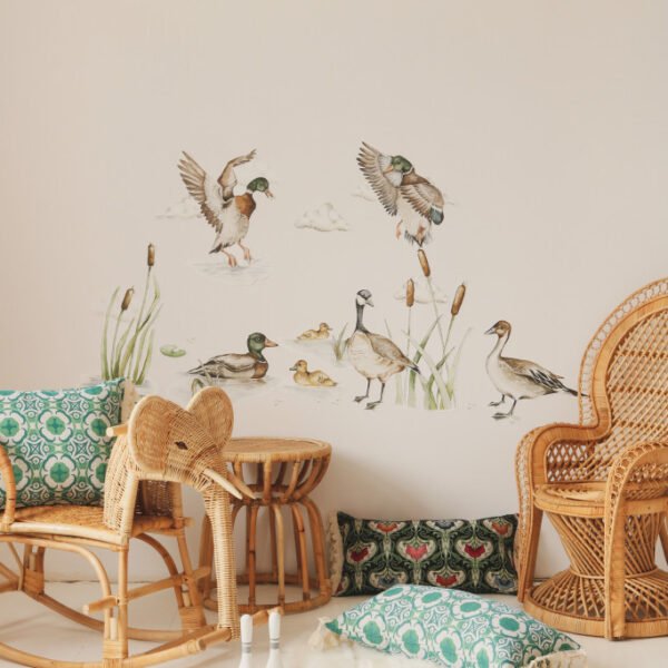 Children's room with wall stickers showing flying and swimming ducks in a thicket with plants and clouds