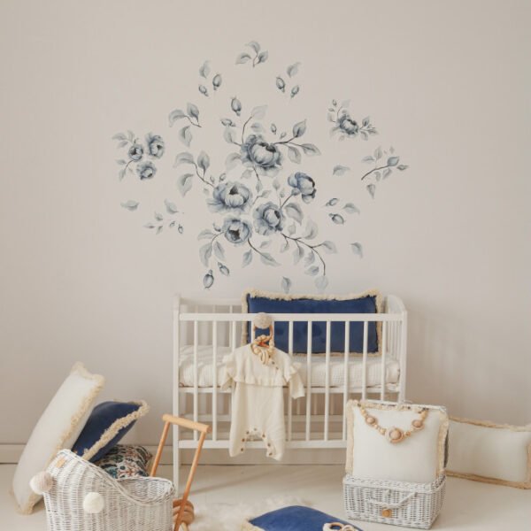 Baby room with baby bed and wall stickers with blue roses in vintage design
