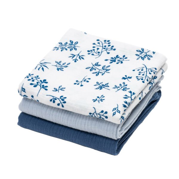 three folded muslin cloths: dark blue, light blue and with floral design