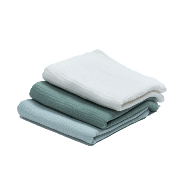 three folded muslin cloths, one all petrol, the second all white and the third light blue