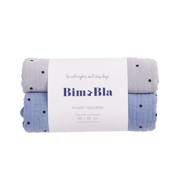 two muslin cloth diapers with a polka dot design, one in gray and the second in blue, in the original packaging with a label