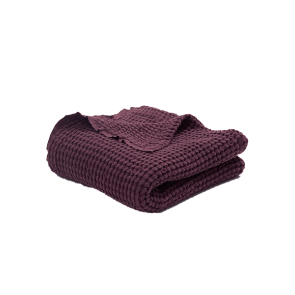 A folded Waffle Baby linen blanket in dark cherry colour