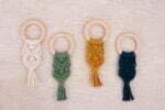 Boho teething rings with a wooden ring, braided with natural cord and in ecru, green, yellow and navy blue color