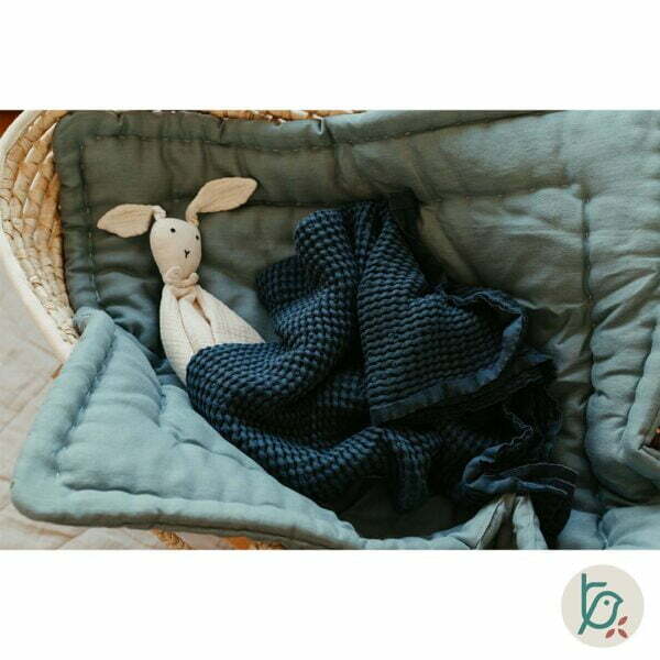 Moses basket with baby horn and A folded Waffle linen blanket in navy blue colour