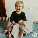 Little boy with a fleece bio cotton blanket for baby